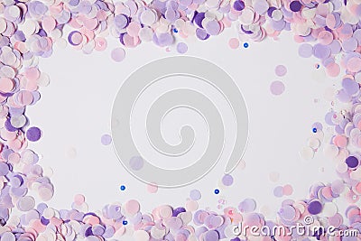 top view of frame of violet confetti pieces on white surface Stock Photo