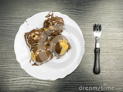 Top view of a French dessert - Profiterole on a plate. Stock Photo