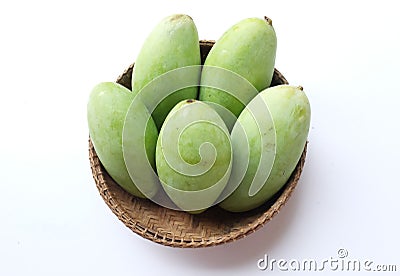 Fresh organic Barracuda mangoes fruit in a beautiful Thai wicker on white background in Thailand. Tropical fruit in thailand. Stock Photo