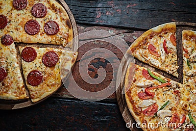 Top view of fresh tasty pizzas on wooden background Stock Photo