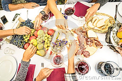 Top view of friend hands eating food and wine at barbecue garden Stock Photo