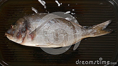 TOP VIEW: Frying Dorade fish on a pan Stock Photo