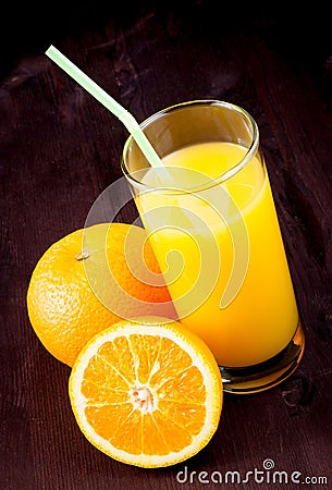 Top of view of full glass of orange juice with straw near fruit orange Stock Photo