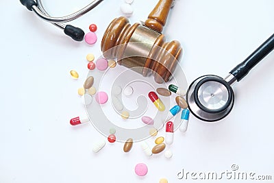 Top view of gavel, stethoscope and pill on white Stock Photo