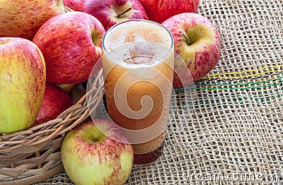 Top view of a glass of freshly squeezed apple juice with red ripe apples on the side juice Stock Photo