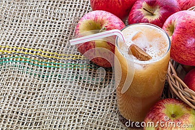 Top view of a glass of freshly squeezed apple juice with red ripe apples on the side Stock Photo