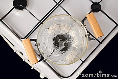 Top view of glass saucepan with boiling eggs on a gas stove Stock Photo