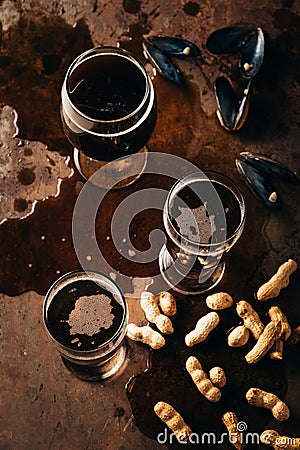 top view of glasses of cold beer peanuts and mussels shells Stock Photo