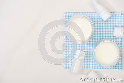 Top view of glasses of homemade yogurt and containers with starter cultures on cloth Stock Photo