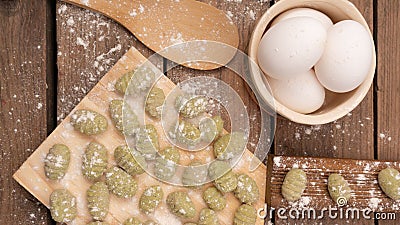 Top view of Gnocchis on a wooden dock with flour on them Stock Photo