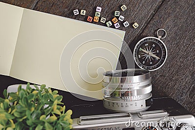 Top view green plant, compass, vintage camera and souvenir Stock Photo