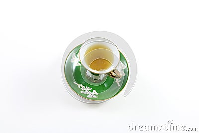 Top view of green and white teacup and saucer with tea Stock Photo