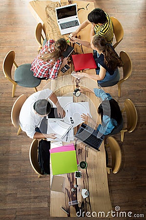 Top view Group of teenage friends working and meeting in team with reports Stock Photo