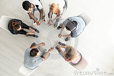 Top view on group of teenagers sitting in a circle during consul Stock Photo