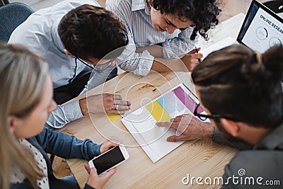 A top view of group of young businesspeople working together in a modern office. Stock Photo