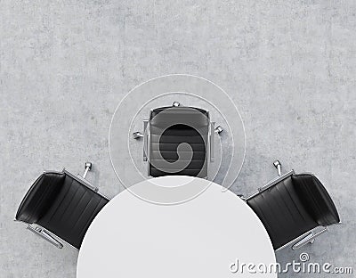 Top view of a half of the conference room. A white round table, three black leather chairs. Office interior. Stock Photo