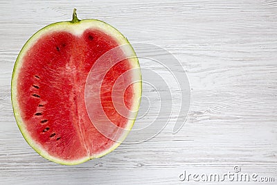 Top view, half cutted watermelon on white wooden table. From above. Stock Photo