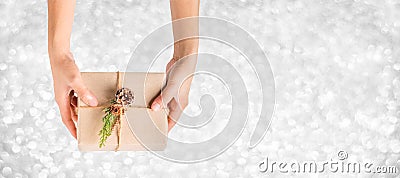 Top view hand holding xmas present box with silver sparkle bokeh background,Banner mock up for adding your text,chrismas Gift Stock Photo