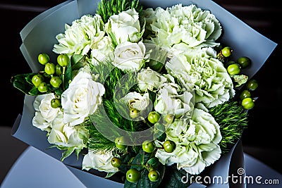 Top view on handmade elegant bouquet of big white roses and fresh greenery Stock Photo