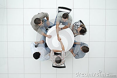 Top view. handshake colleagues at the round table. Stock Photo