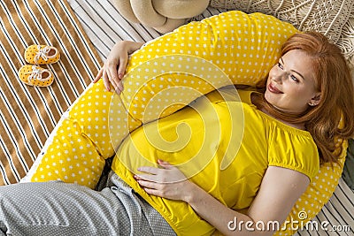 Top view happy future mother lying on comfortable bed hugging pillow for pregnant relaxing Stock Photo