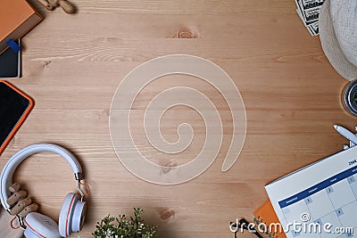 Headphone, mobile phone, calendar and notebook on wooden background. Stock Photo