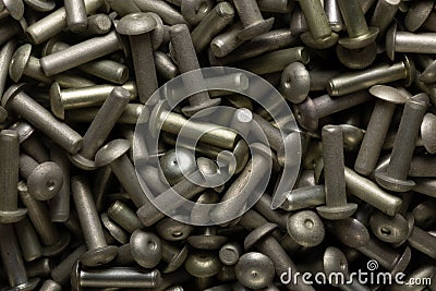Top view of heap of dark gray steel rivets Stock Photo