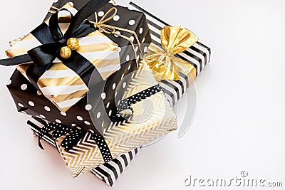 Top view of a heap of gift boxes in various black, white and golden designs. A concept of Christmas, New Year, birthday celebratio Stock Photo