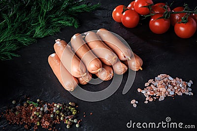 Top view on heap of long sausages with rucola and tomatoes Stock Photo