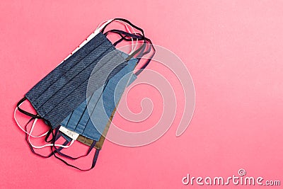 Top view of heap of protective cotton masks on pink background. Protect your health concept with copy space Stock Photo