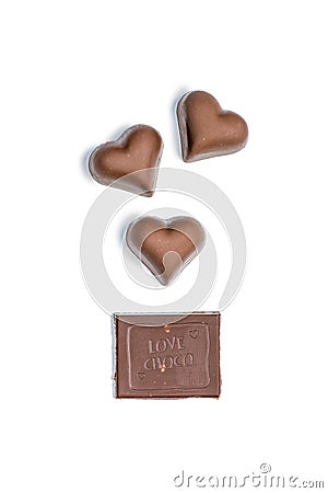 Top view of heart shaped candies and piece of chocolate bar Stock Photo