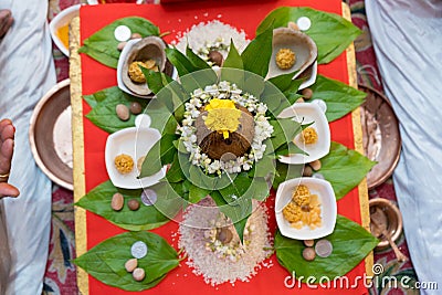 top view of hindu pooja arrangements done using betel leafs, flowers, coconut, rice and areca nuts which means supari Stock Photo