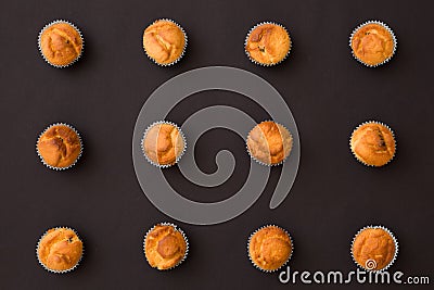 Top view on homemade vanilla muffins places in rows on black background. Healthy snack Stock Photo