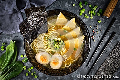 Top view of homemade vegetarian Japanese Ramen noudle soup with fried tofu slices, egg and spring onions Stock Photo