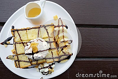 Top view of honey toast with ice cream, chocolate, whip cream and cereal topped. Stock Photo