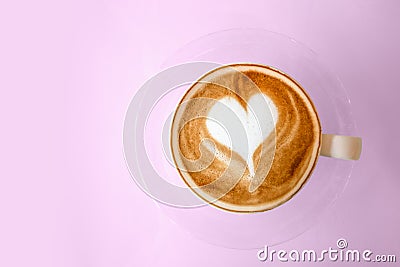 Top view of hot coffee latte with heart shaped latte art milk foam on pink pastel color sweet background. Stock Photo