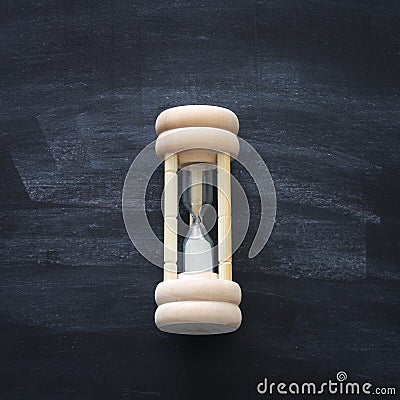 Top view of hourglass over chalkboard background. Stock Photo