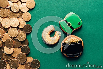 top view of icing cookies and golden coins on green, st patricks day concept Stock Photo