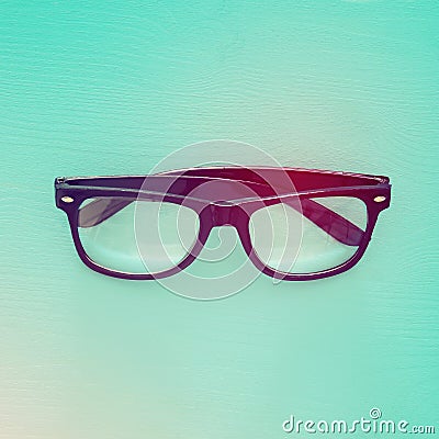 Top view image of black optical glasses over mint wooden background. Stock Photo