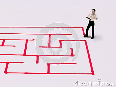 Top view image a businessman navigating through a maze. Stock Photo