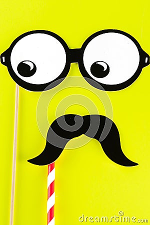 Top view image of funny masks on yellow background. International Men`s Day. Stock Photo