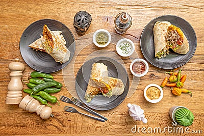 Top view image of Mexican burritos with peppers, sauces, fresh pepper, black skull Stock Photo