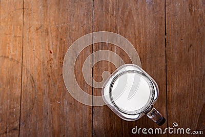 top view image milk in a jug and a glass on wooden table Stock Photo