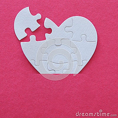 Top view image of paper white heart puzzle with missing piece over pink background. Health care, donate, world heart day and world Stock Photo