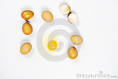 Top view image of raw eggs and one of them broken showing yolk and white Stock Photo