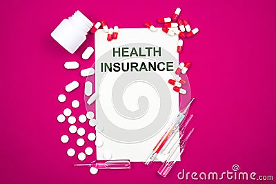 Top view of the inscription health insurance on white paper. Stock Photo