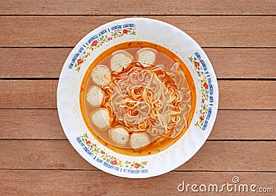 Top view instant noodles with meat balls in ceramic bowl against wooden plank Stock Photo