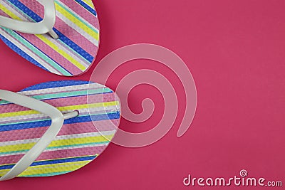 Top view on isolated colorful striped pair flip flops on pink background with copy space Stock Photo