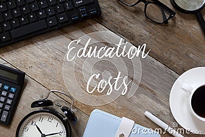 Top view of keyboard,glasses, magnifying glass, a cup of coffee,pen, notebook, clock and calculator on wooden background written Stock Photo