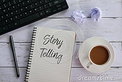 Top view of keyboard,trash paper,coffee,pen and notebook written with Story Telling. Stock Photo